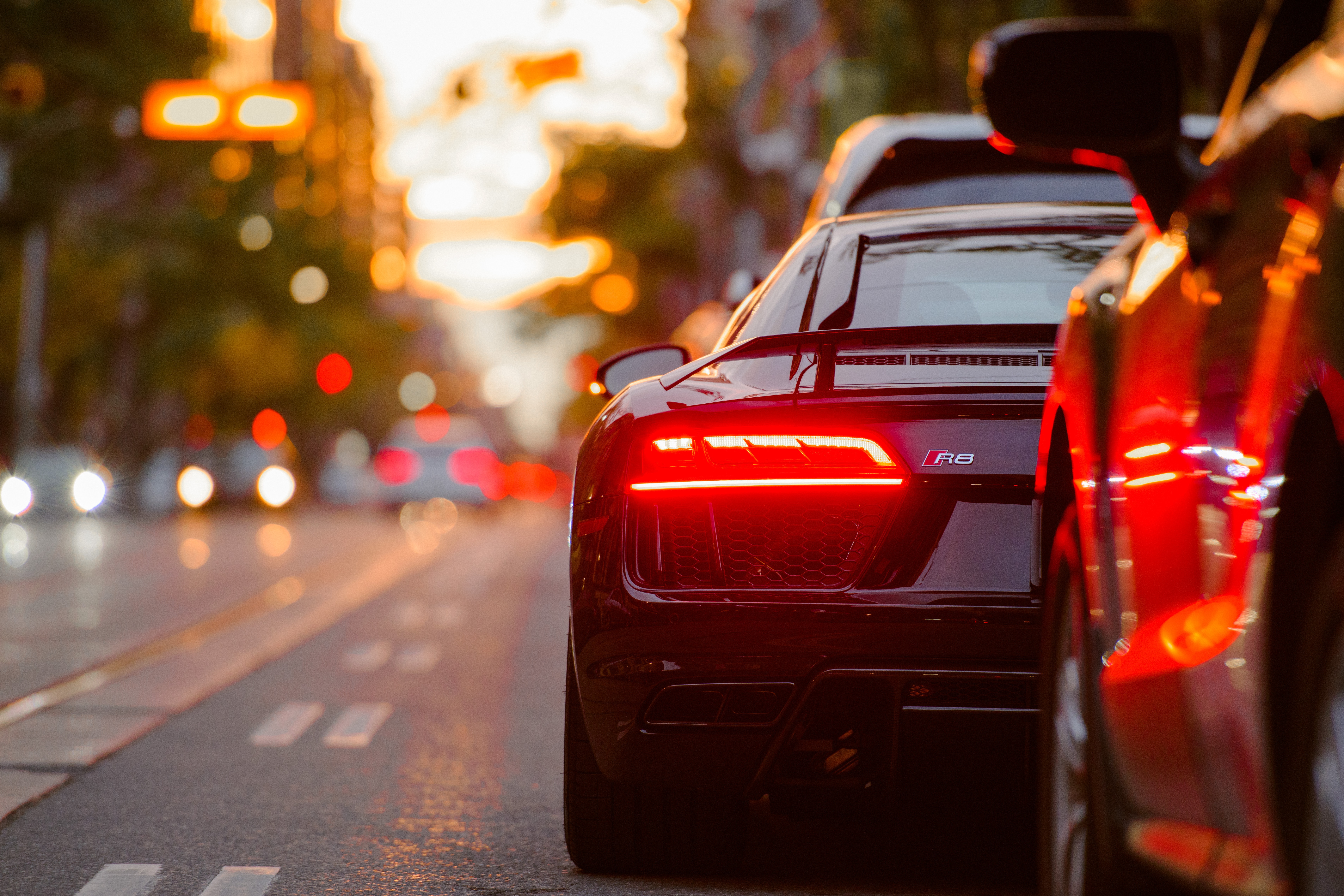 Photo by Evgeny Tchebotarev black Audi R8 parked beside road